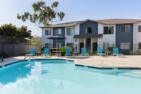 San Ysidro apartment for rent - A swimming pool in front of a multi-story apartment building.