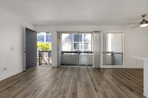 San Ysidro apartment for rent - A room with wooden floors and a ceiling fan.