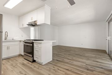 San Ysidro apartment for rent - A kitchen with white cabinets and a wooden floor.