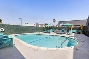National City apartment for rent - A small pool with a metal railing and a few chairs around it.