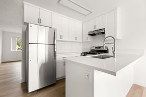 San Ysidro apartment for rent - A modern kitchen with a stainless steel refrigerator and white cabinets.