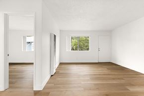 San Ysidro apartment for rent - A room with white walls and wooden flooring with a window.