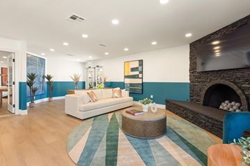 Escondido apartment for rent - A living room with a white couch and a fireplace.
