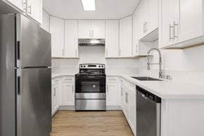 Escondido apartment for rent - A modern kitchen with white cabinets and stainless steel appliances.