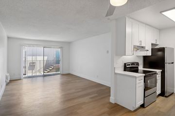 El Cajon apartment for rent - A kitchen with white cabinets and a black stove top oven.