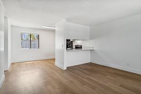 El Cajon apartment for rent - A room with wooden flooring and a window with blinds.