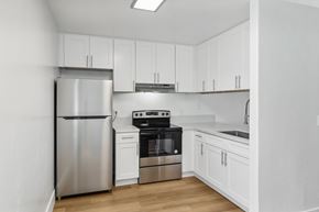 El Cajon apartment for rent - A kitchen with white cabinets and stainless steel appliances.