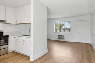 El Cajon apartment for rent - A kitchen with white cabinets and a window.
