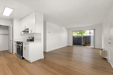 El Cajon apartment for rent - A kitchen with white cabinets and a wooden floor.