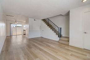 El Cajon apartment for rent - A spacious room with wooden floors and a staircase.