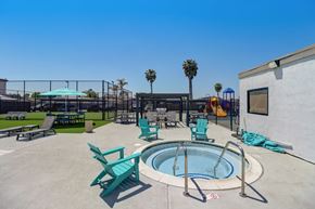 El Cajon apartment for rent - A pool area with a hot tub and lounge chairs.