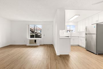 Ramona apartment for rent - A kitchen with white cabinets and a stainless steel refrigerator.