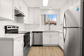 Ramona apartment for rent - A modern kitchen with white cabinets and stainless steel appliances.