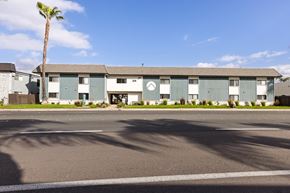 El Cajon apartment for rent - A building with a palm tree in front of it.