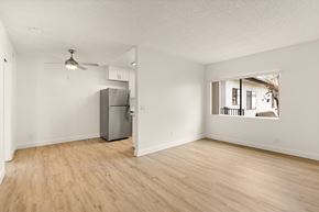 El Cajon apartment for rent - A room with a refrigerator and a ceiling fan.