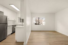 El Cajon apartment for rent - A kitchen with white cabinets and a stainless steel refrigerator.
