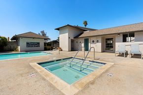 El Cajon apartment for rent - A pool with a diving board in front of a house.