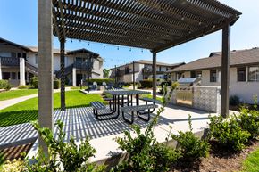 El Cajon apartment for rent - A patio with a table and chairs under a pergola.