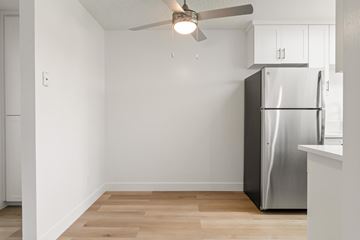 El Cajon apartment for rent - A kitchen with a refrigerator and a ceiling fan.