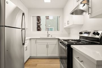 El Cajon apartment for rent - A modern kitchen with white cabinets and stainless steel appliances.