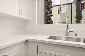 El Cajon apartment for rent - A kitchen with white cabinets and a silver sink.