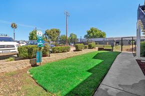Ramona apartment for rent - A green sign is on a post in front of a grassy area.