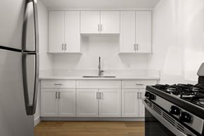 El Cajon apartment for rent - A modern kitchen with white cabinets and a stainless steel refrigerator.