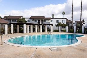 El Cajon apartment for rent - A swimming pool in front of a row of houses.