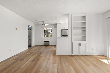 El Cajon apartment for rent - A kitchen with white cabinets and a wooden floor.
