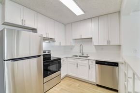 El Cajon apartment for rent - A kitchen with white cabinets and stainless steel appliances.