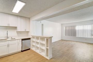El Cajon apartment for rent - A kitchen with white cabinets and a wooden floor.