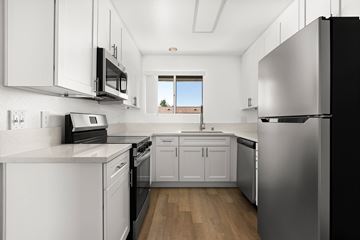 Ramona apartment for rent - A modern kitchen with stainless steel appliances and white cabinets.
