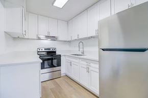 Ramona apartment for rent - A modern kitchen with white cabinets and stainless steel appliances.