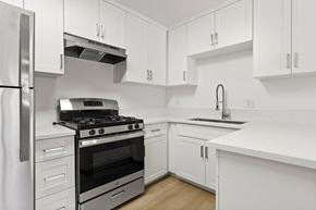 El Cajon apartment for rent - A modern kitchen with white cabinets and stainless steel appliances.