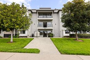 San Diego apartment for rent - A building with a tree in front of it.