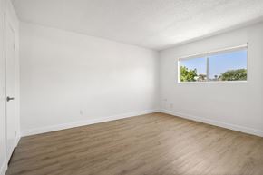 Spring Valley apartment for rent - Empty room with a window and wooden floor.