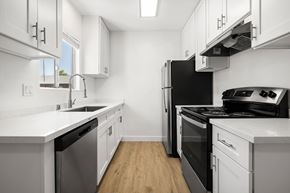 Spring Valley apartment for rent - A modern kitchen with white cabinets and stainless steel appliances.