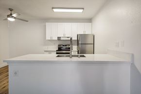 Spring Valley apartment for rent - A kitchen with a stainless steel refrigerator and a white countertop.
