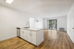 Spring Valley apartment for rent - A kitchen with white cabinets and a wooden floor.