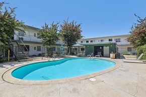 Spring Valley apartment for rent - A small pool in a courtyard surrounded by buildings.