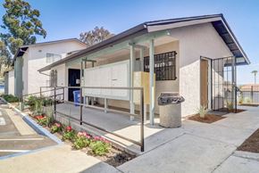 Spring Valley apartment for rent - A modern building with a white facade and a blue roof.