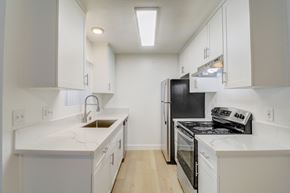 Spring Valley apartment for rent - A kitchen with white cabinets and appliances.