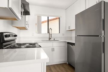 Escondido apartment for rent - A modern kitchen with a stainless steel refrigerator and white countertops.