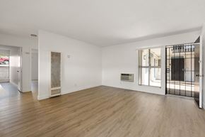 La Mesa apartment for rent - A spacious room with wooden floors and white walls.