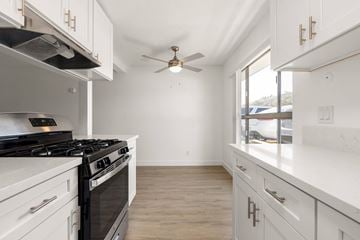 La Mesa apartment for rent - A white kitchen with a black stove top oven.