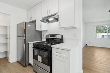 Escondido apartment for rent - A modern kitchen with a stainless steel refrigerator, a white oven, and a black stove top.