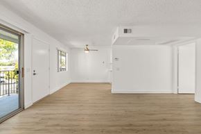 Escondido apartment for rent - A spacious room with wooden flooring and white walls.