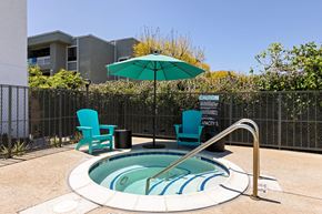Escondido apartment for rent - A small pool with a blue striped border and a metal fence surrounding it.