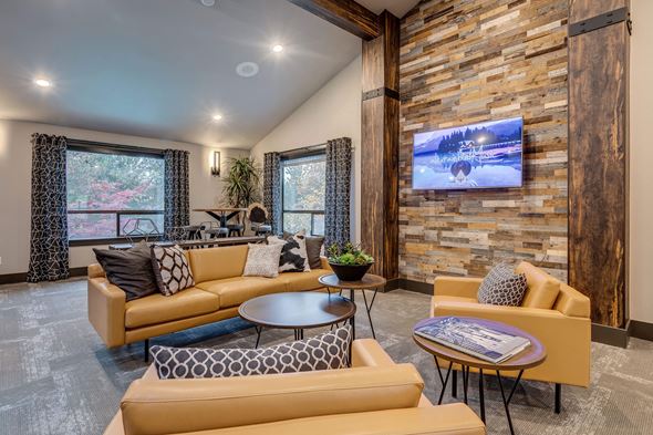 Lynnwood apartment for rent - A living room with a stone wall and a television mounted on it.