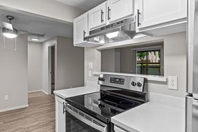 Lynnwood apartment for rent - A modern kitchen with a stove top oven and a microwave above it.